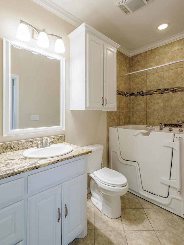 bathroom with vanity, crown molding, toilet, and washer / dryer