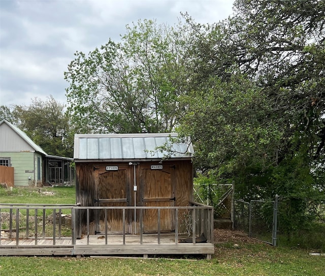 exterior space featuring a wooden deck and a shed