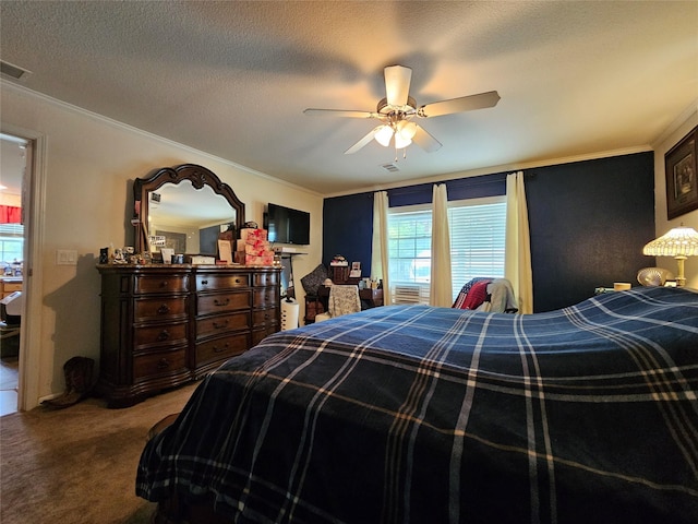 carpeted bedroom featuring ceiling fan, a textured ceiling, and ornamental molding