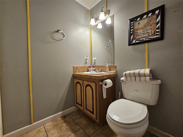 bathroom featuring toilet, vanity, tile patterned floors, and crown molding