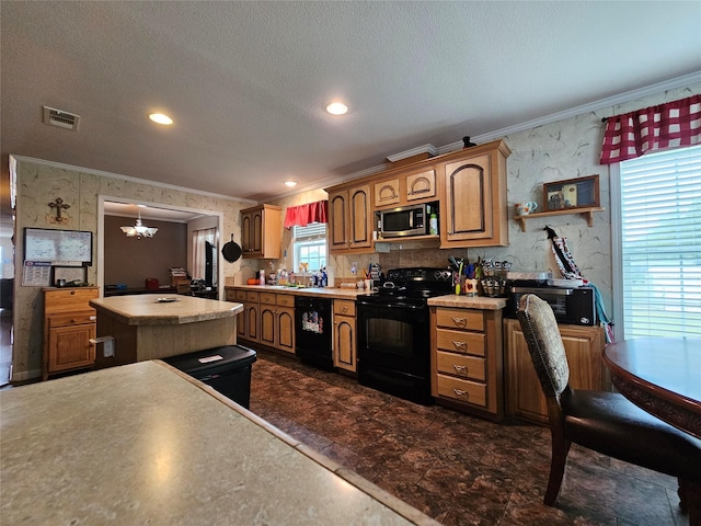 kitchen with a kitchen island, black appliances, a textured ceiling, and ornamental molding