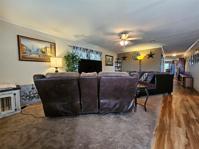 living room with hardwood / wood-style flooring, ceiling fan, and crown molding