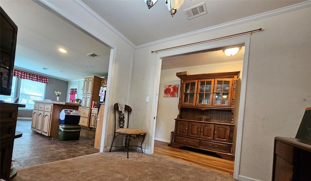 interior space with ornamental molding and dark colored carpet