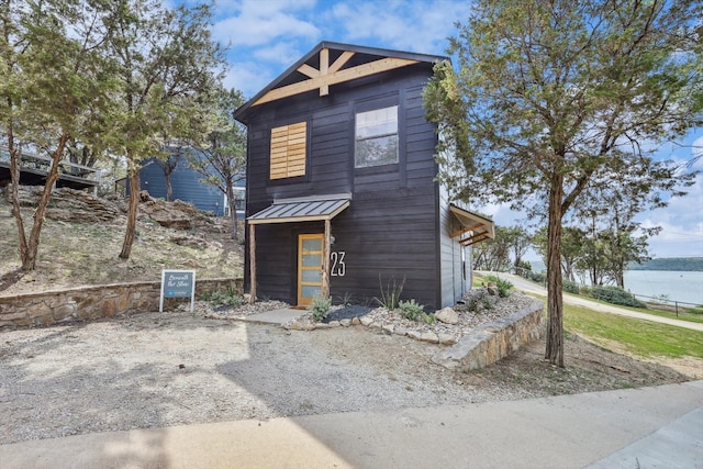 view of front of home with a water view