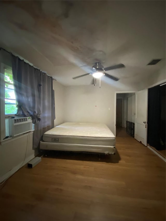 bedroom with ceiling fan and hardwood / wood-style flooring