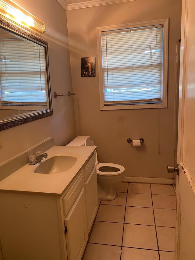 bathroom with ornamental molding, tile floors, vanity, and toilet