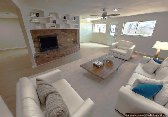 living room featuring built in shelves, ceiling fan, and a brick fireplace