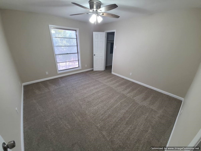 spare room featuring carpet floors and ceiling fan