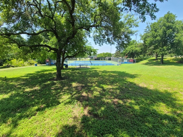 view of yard with tennis court