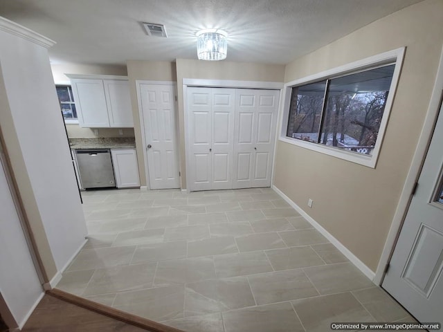 hallway featuring light tile patterned flooring and an inviting chandelier