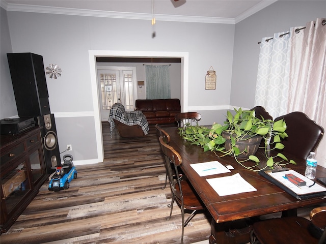 dining area featuring hardwood / wood-style floors and ornamental molding