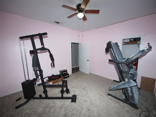 workout room with ceiling fan and carpet floors