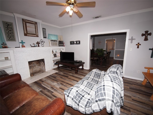 living room with crown molding, a fireplace, ceiling fan, and dark wood-type flooring