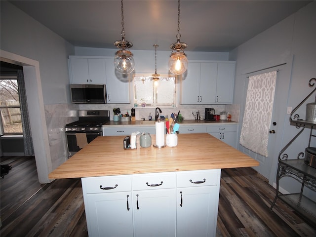 kitchen with a kitchen island, white cabinetry, and appliances with stainless steel finishes