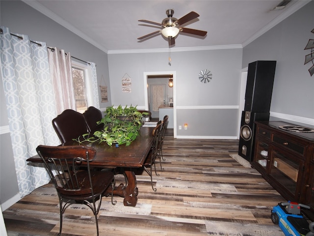 dining area with ceiling fan, dark hardwood / wood-style flooring, and ornamental molding