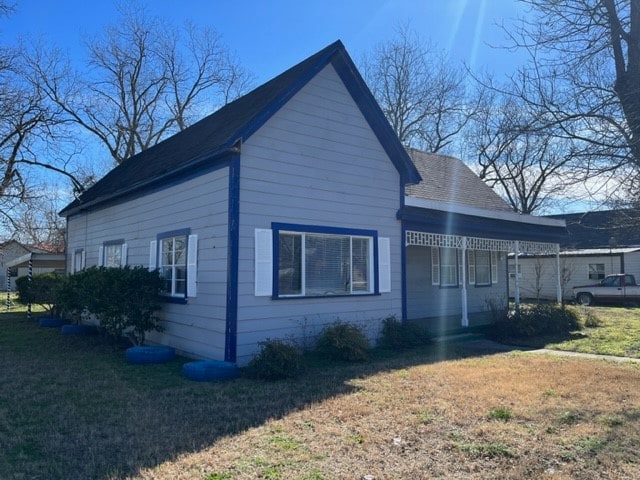 view of property exterior with a yard