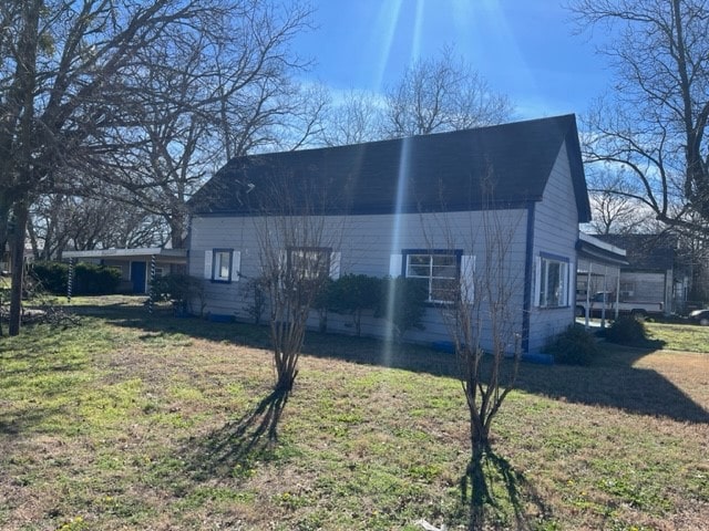 view of home's exterior with a lawn