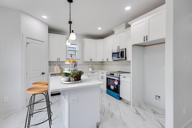 kitchen featuring a kitchen island, appliances with stainless steel finishes, white cabinets, backsplash, and light tile floors