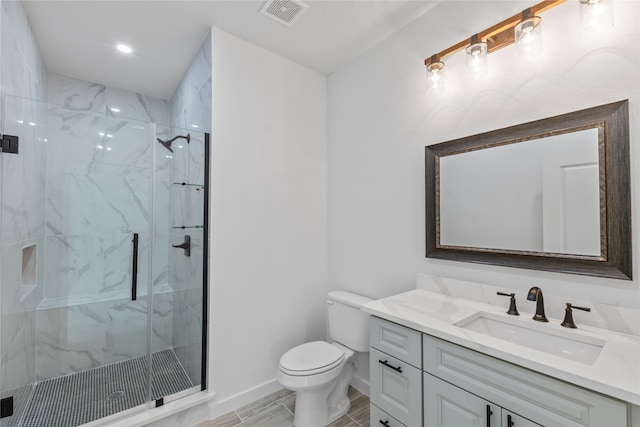 bathroom with a shower with shower door, tile flooring, vanity, and toilet