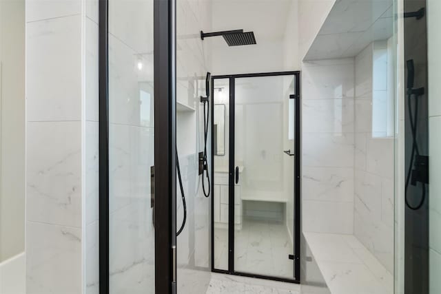 bathroom featuring a marble finish shower