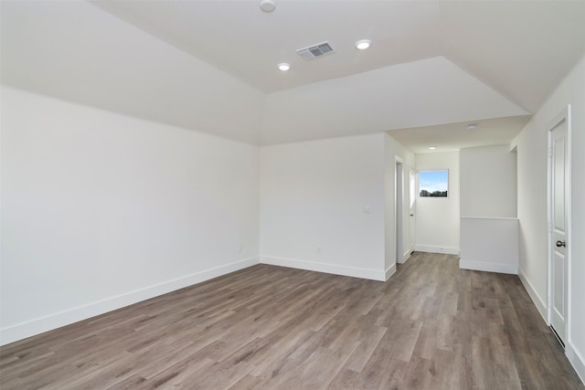 spare room with recessed lighting, visible vents, baseboards, and wood finished floors