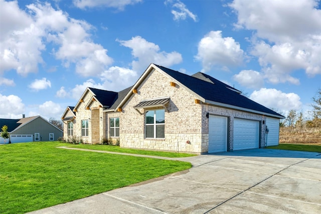 view of front of house featuring driveway, a garage, stone siding, a front lawn, and brick siding