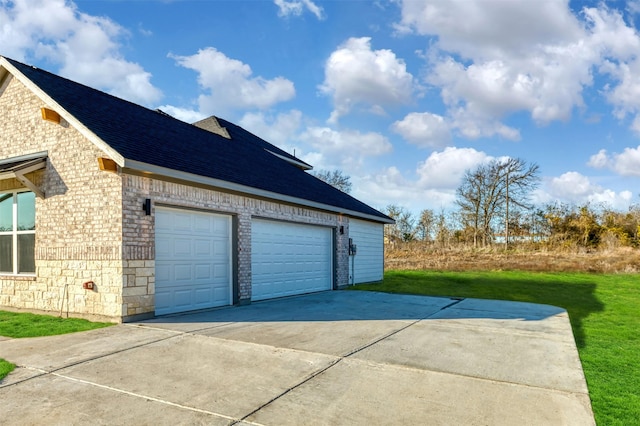 garage featuring concrete driveway