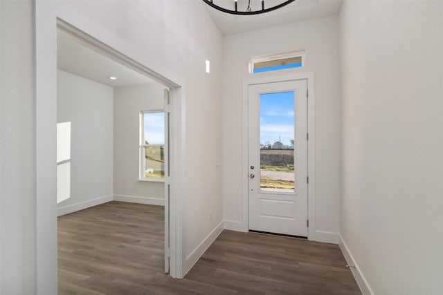 entryway featuring dark wood-style flooring and baseboards