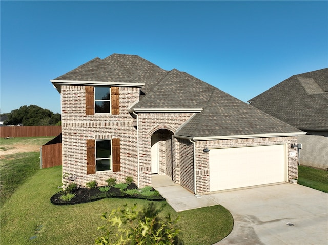 view of front of house featuring a garage and a front lawn