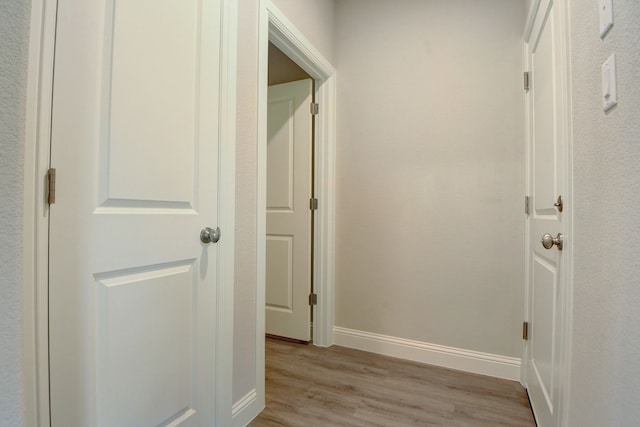 hallway with light hardwood / wood-style flooring