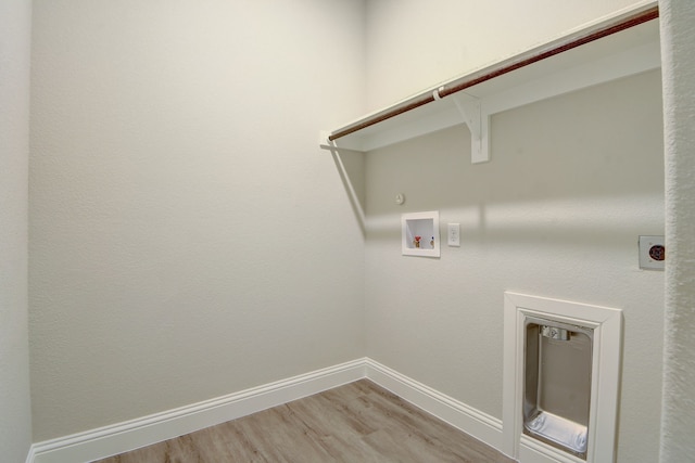 washroom featuring hookup for a washing machine, gas dryer hookup, hookup for an electric dryer, and light hardwood / wood-style flooring