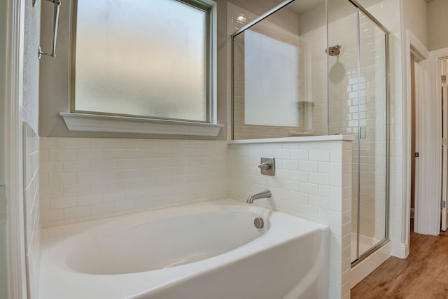 bathroom with separate shower and tub and hardwood / wood-style floors