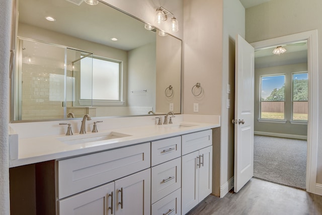 bathroom with vanity, a shower with door, and hardwood / wood-style flooring