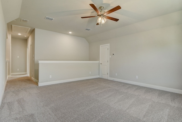 unfurnished room featuring light carpet, lofted ceiling, and ceiling fan