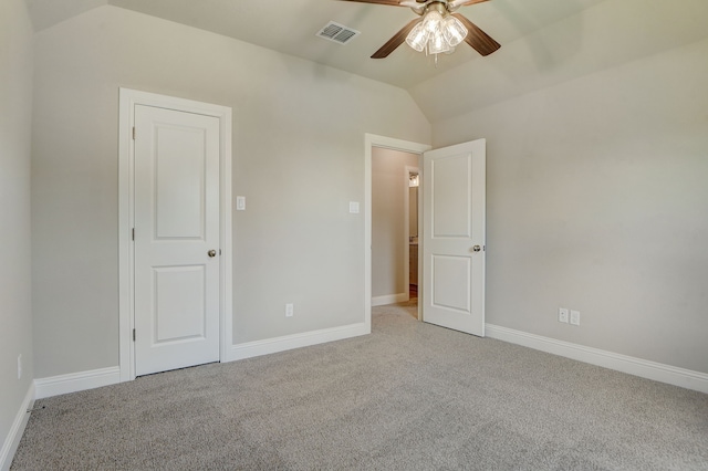 unfurnished bedroom featuring vaulted ceiling, carpet flooring, and ceiling fan