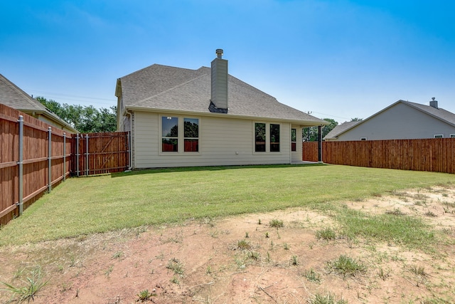 rear view of property with a yard