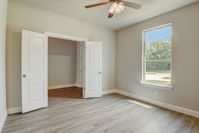 unfurnished bedroom with ceiling fan and light hardwood / wood-style flooring