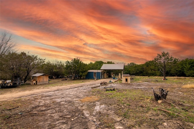 view of front of property with a storage shed