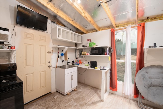 kitchen featuring light hardwood / wood-style floors, electric range oven, white cabinetry, and sink