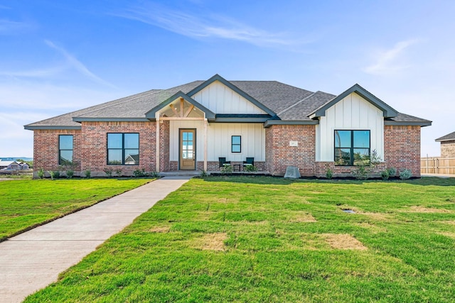 227 Rio Grande, Abilene, TX 79606 - view of front of property with a shingled roof, board and batten siding, and a front lawn