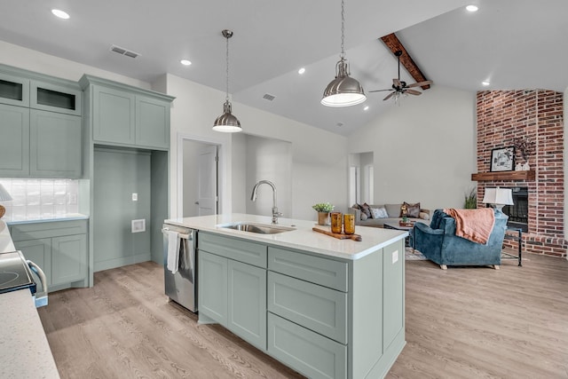 227 Rio Grande, Abilene, TX 79606 - kitchen featuring dishwasher, light wood-type flooring, light countertops, a brick fireplace, and hanging light fixtures