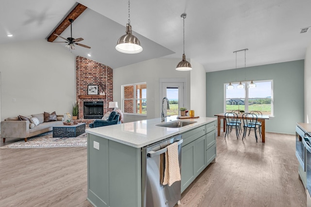 227 Rio Grande, Abilene, TX 79606 - kitchen featuring dishwasher, light wood-style floors, a ceiling fan, and a fireplace