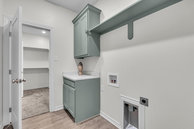 227 Rio Grande, Abilene, TX 79606 - laundry room with hookup for an electric dryer, washer hookup, cabinet space, and light wood-style floors