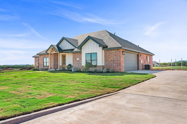 227 Rio Grande, Abilene, TX 79606 - view of front facade featuring board and batten siding, a garage, driveway, a front yard, and brick siding