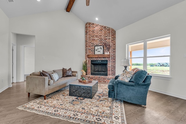 227 Rio Grande, Abilene, TX 79606 - living area featuring high vaulted ceiling, beam ceiling, wood finished floors, and a brick fireplace