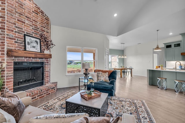 227 Rio Grande, Abilene, TX 79606 - living room with wood finished floors, a fireplace, recessed lighting, and high vaulted ceiling