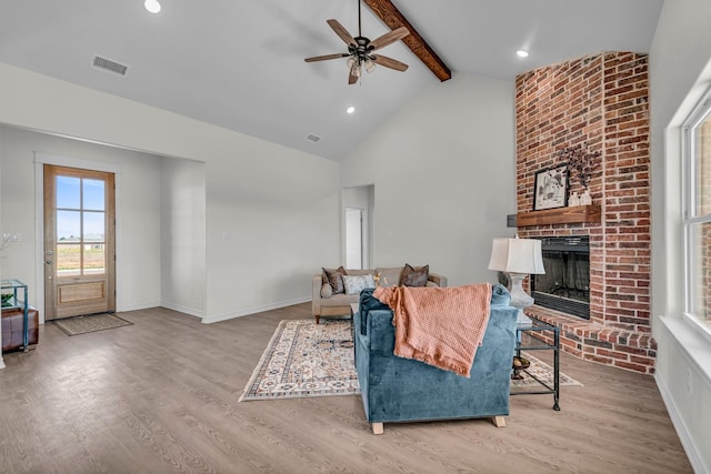 227 Rio Grande, Abilene, TX 79606 - living room featuring plenty of natural light, beamed ceiling, wood finished floors, a brick fireplace, and high vaulted ceiling