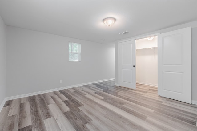 unfurnished room with light wood-type flooring