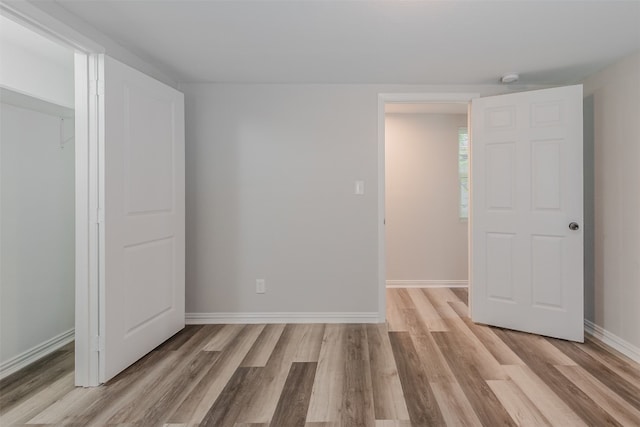 spare room with light hardwood / wood-style flooring