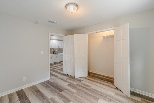 interior space with light hardwood / wood-style flooring and sink